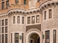 The landmark site is now used by the NYPD Traffic Control Division. The arched central entry leads to an interior courtyard.